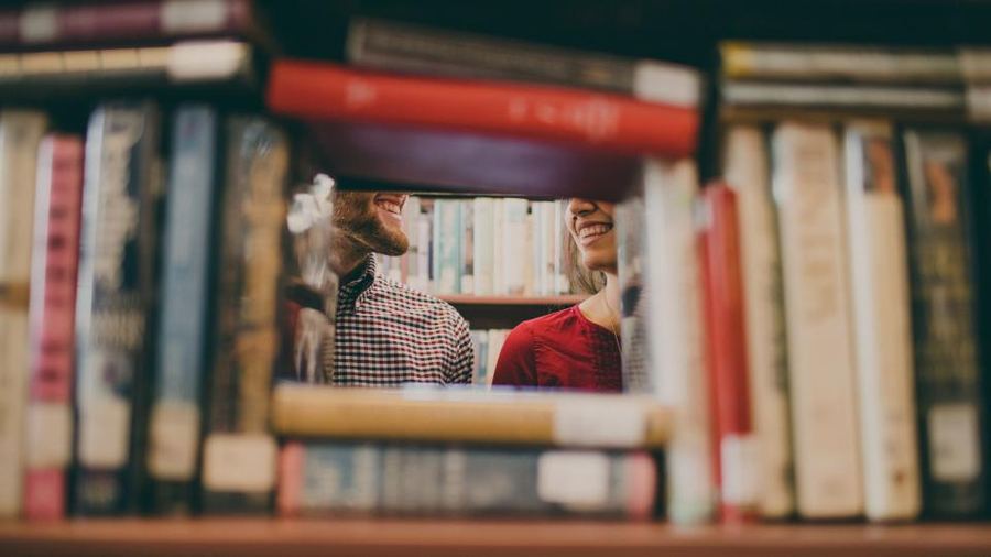 Children looking through a bookshelf