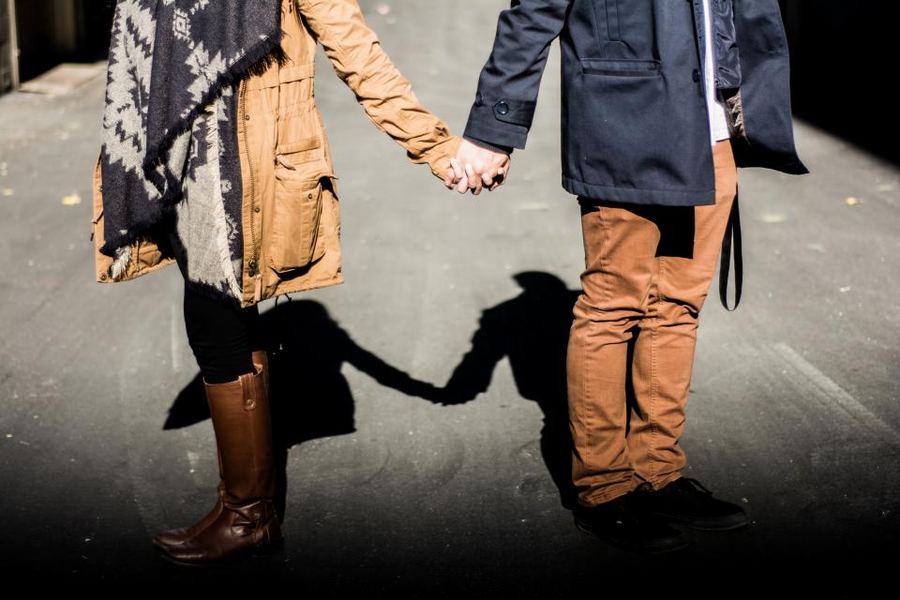 A couple walking hand in hand